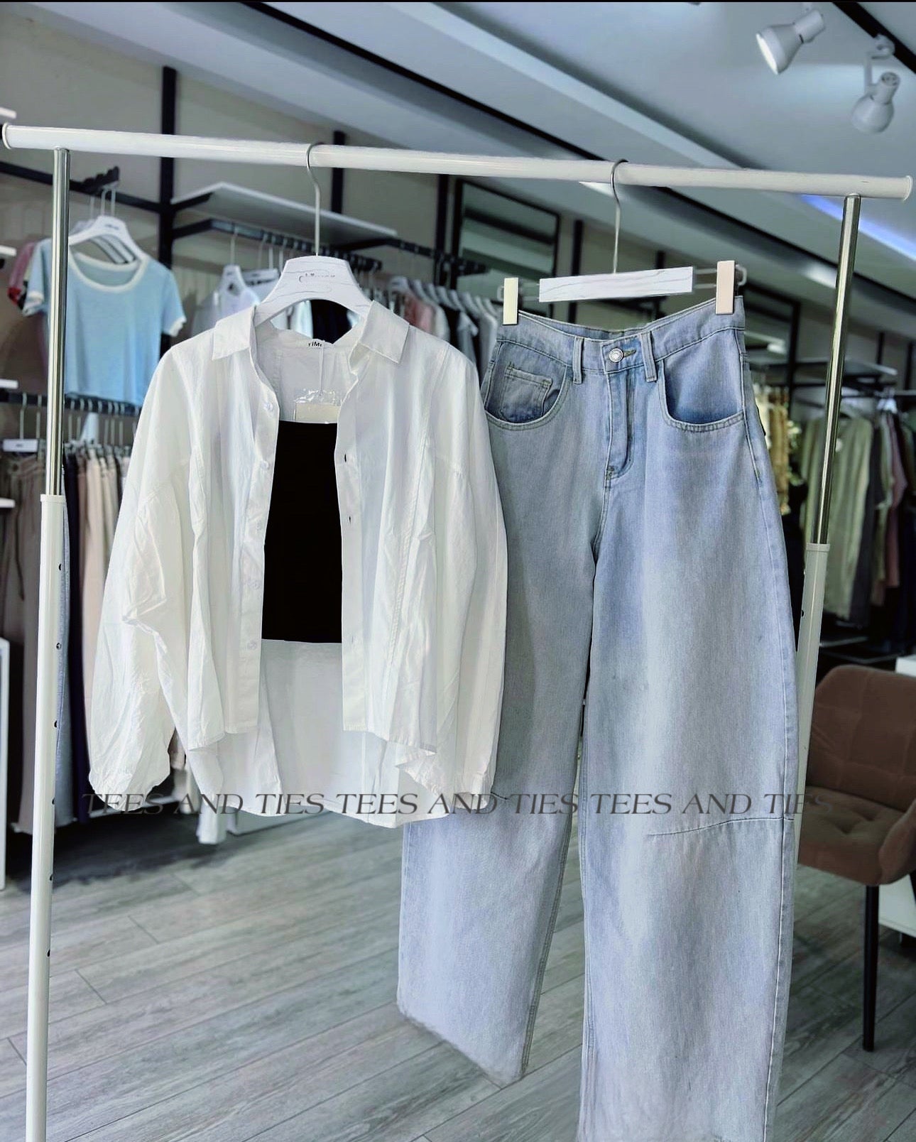 White button down with black inner camisole and mom fit jeans