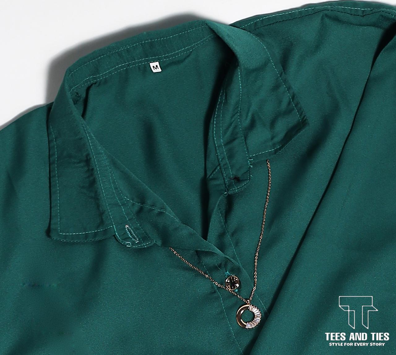 Green button down with white inner camisole and white wide leg jeans