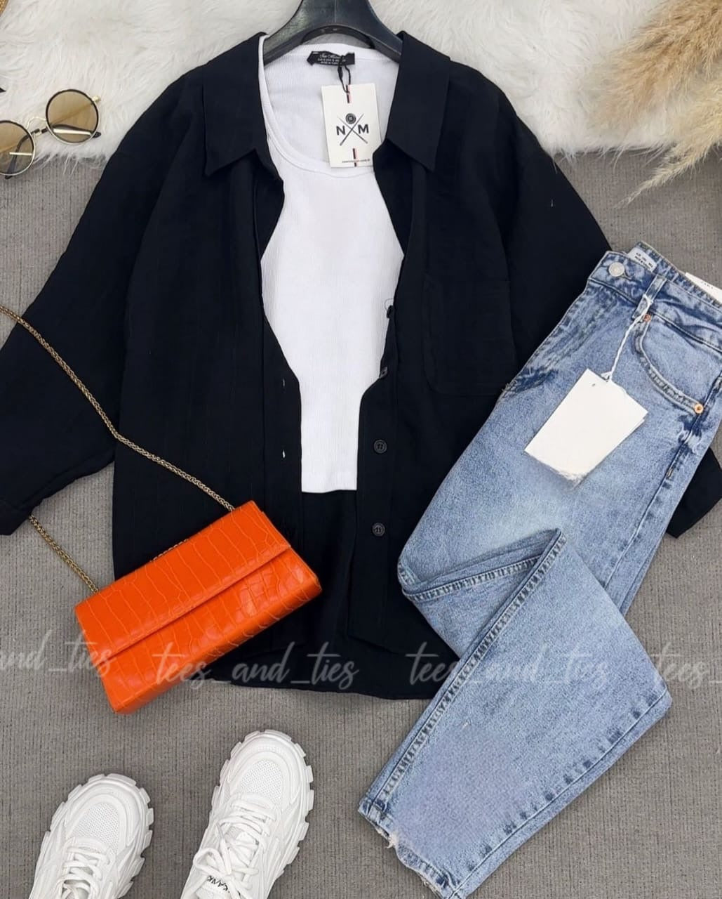 Black button down with white inner camisole and mom fit jeans
