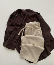 Brown button down with beige flapper trouser