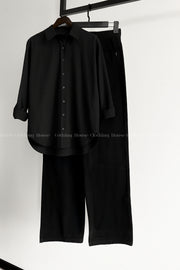Black button down shirt with black wide leg jeans