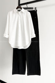 White button down shirt with black wide leg jeans