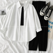 White button down shirt with black trouser and black camisole
